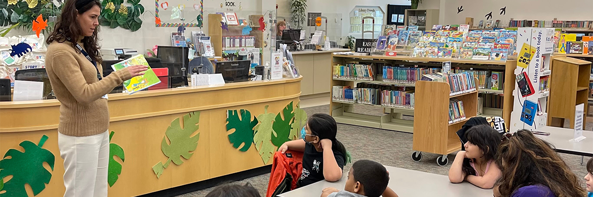 Librarian reading to a classroom of students